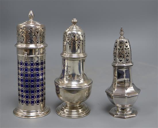 A late Victorian silver lighthouse sugar caster, with blue glass liner, London, 1900, 18.8cm and two later silver sugar casters,